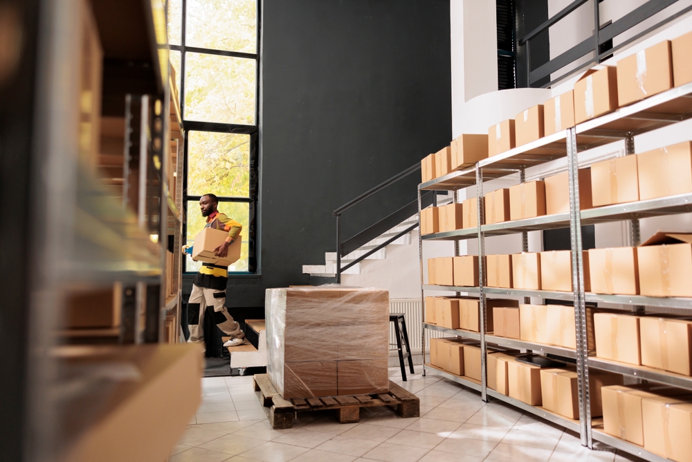 Storage,Room,Worker,Carrying,Cardboard,Box,On,Stairs,During,Warehouse